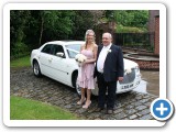 Happy wedding couple next to our baby bentley car, also ideal for Bridesmaids, Grooms and family
